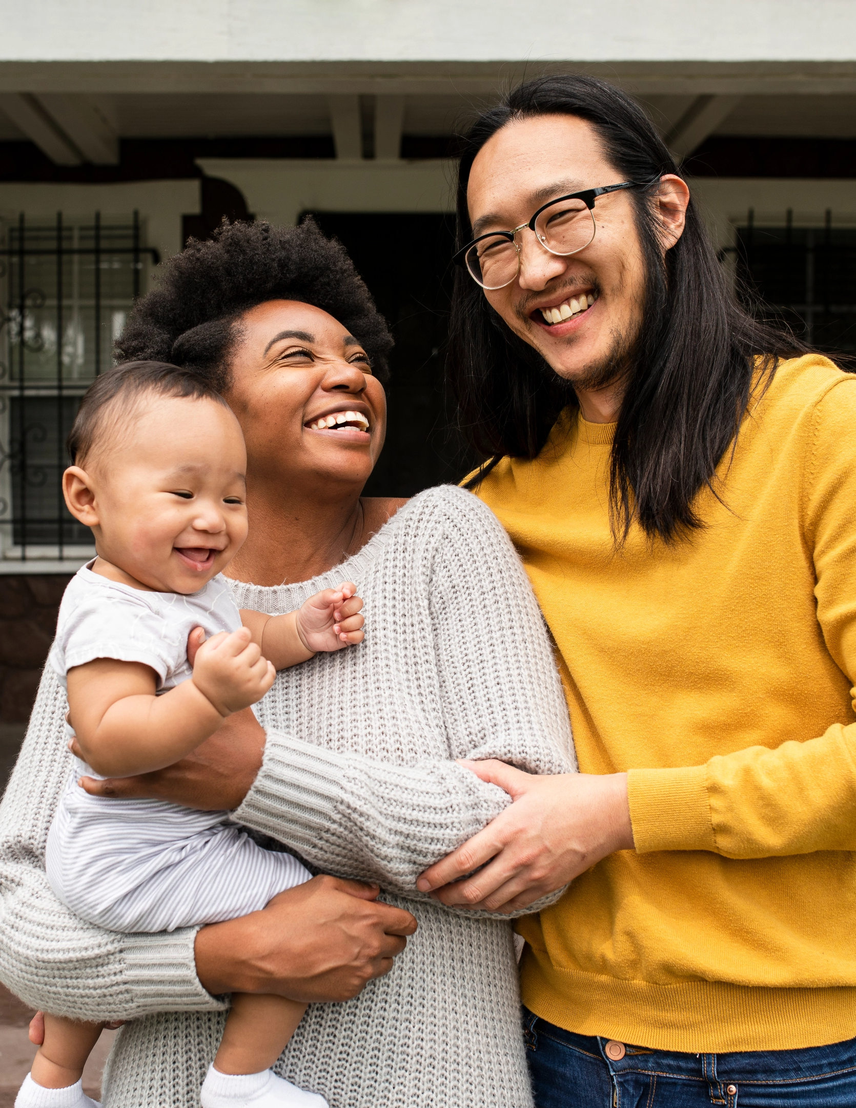 happy interracial couple with baby